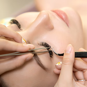 Customer receiving eyelash extensions from a skilled technician